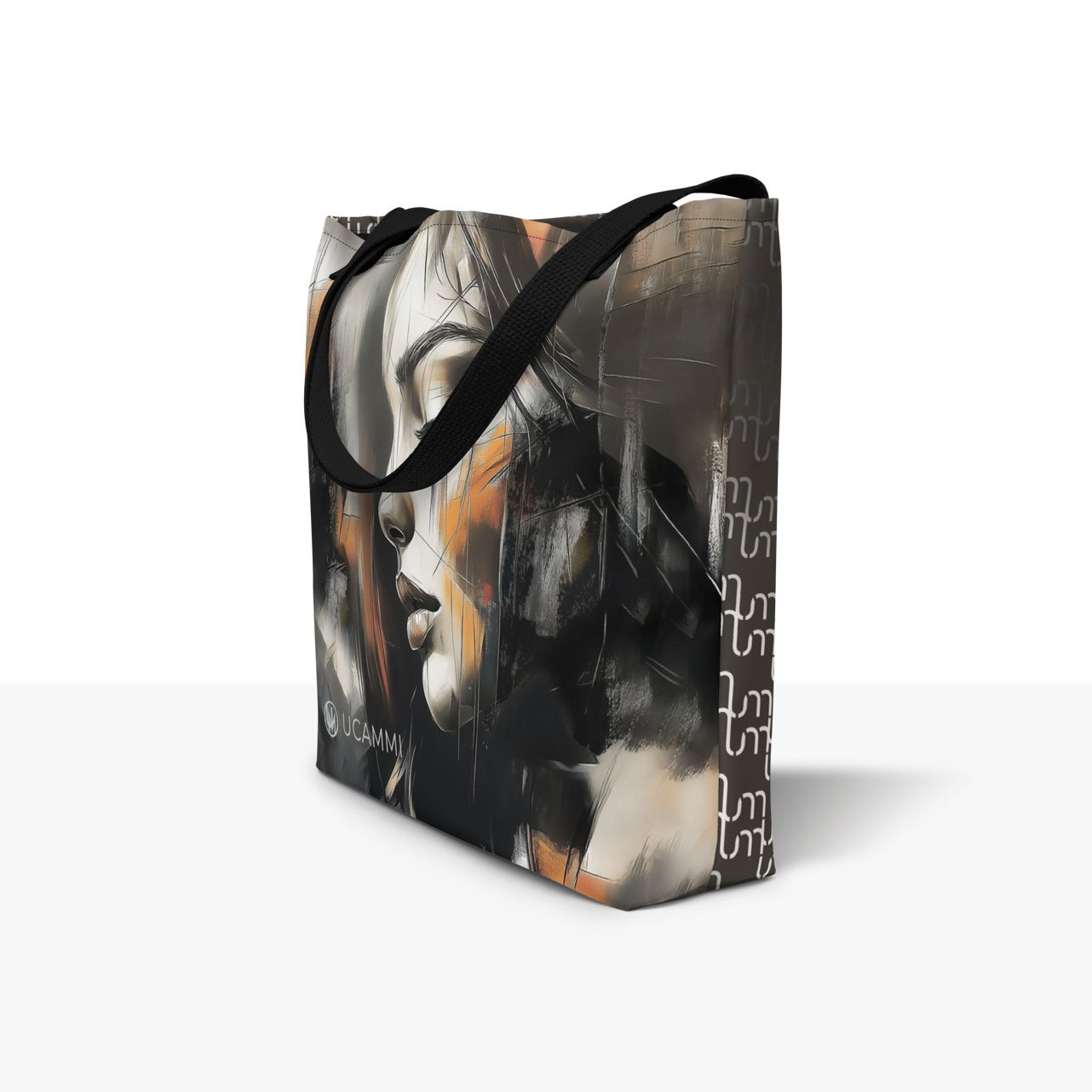 Side view of UCAMMI Atelier Large Tote Bag showing abstract portrait and UCAMMI pattern for women’s art fashion