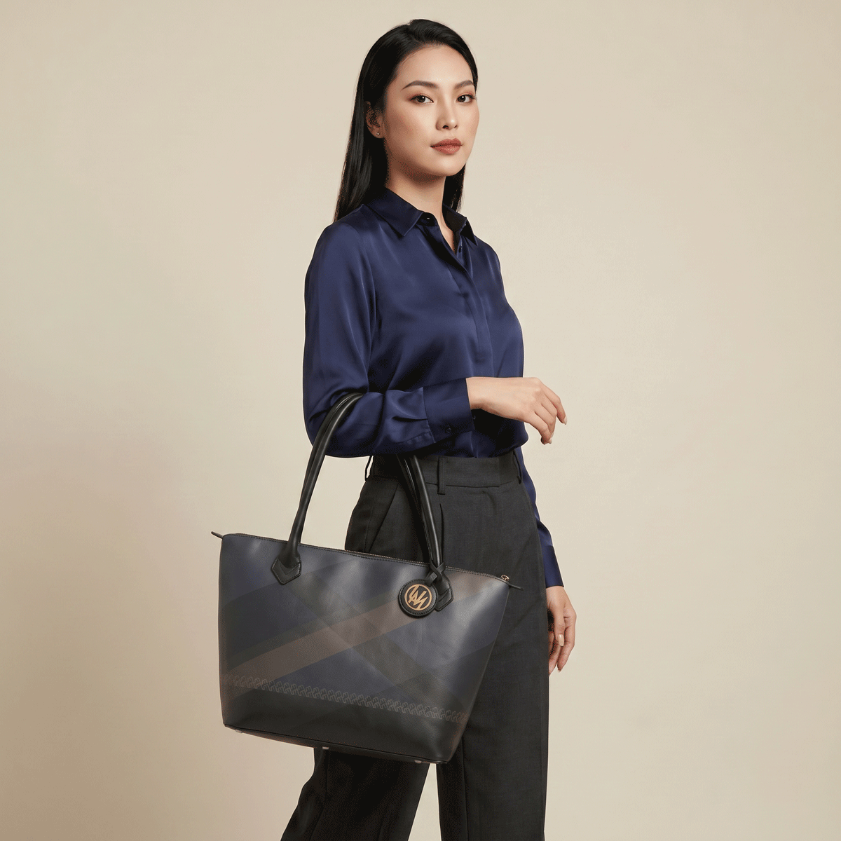 Nappa leather tote bag carried by a woman in a premium studio image