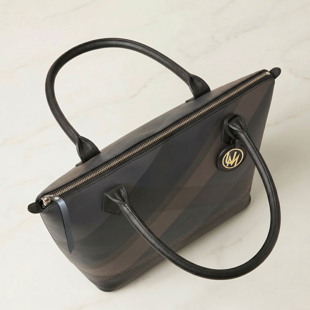 Nappa leather tote bag upper detail with black handles and zip-top closure