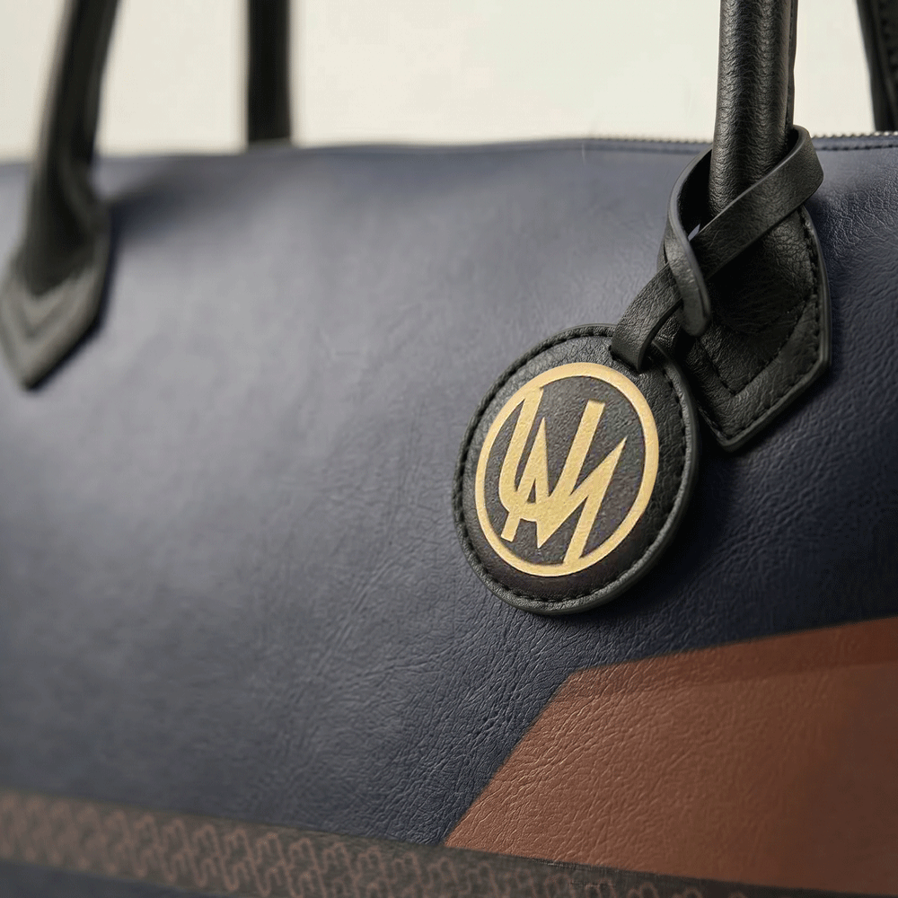 Black leather tote bag close-up showing printed Nappa leather texture and premium finish