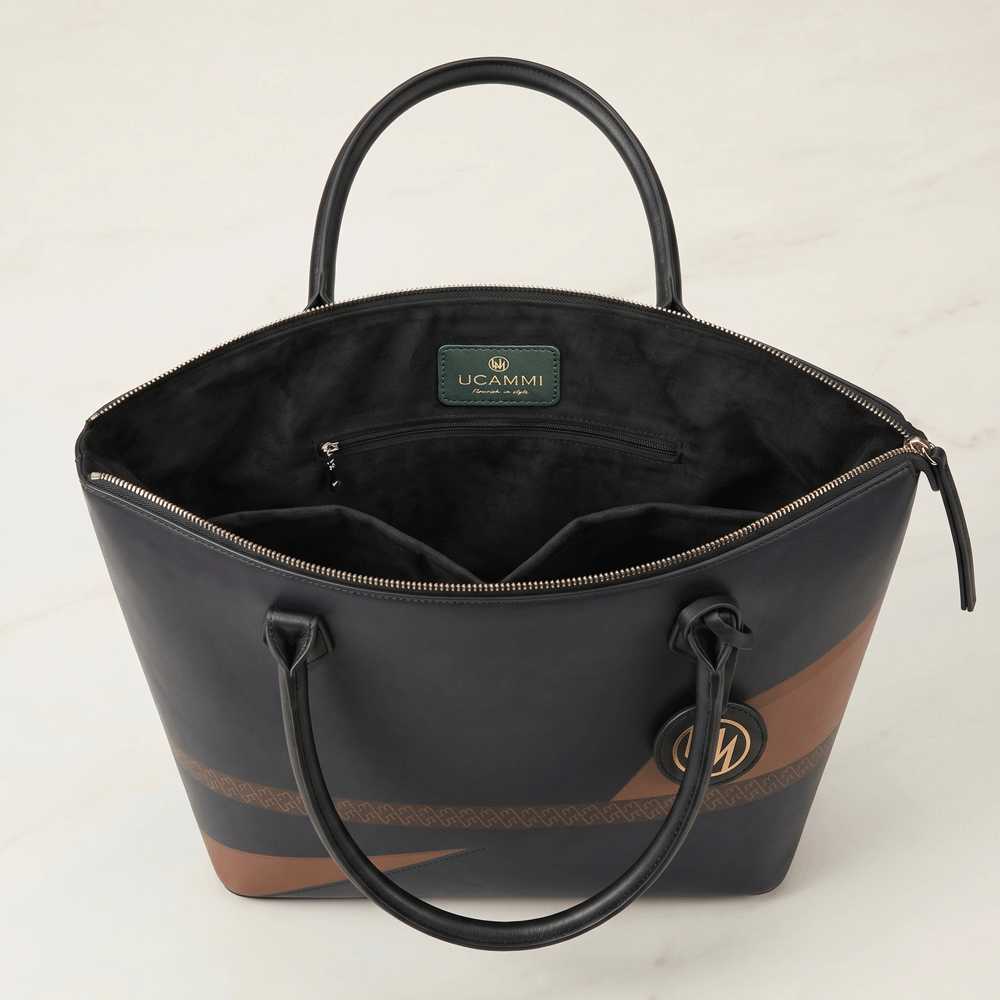 Black leather tote bag open view showing zip-top access, waterproof lining and internal pockets
